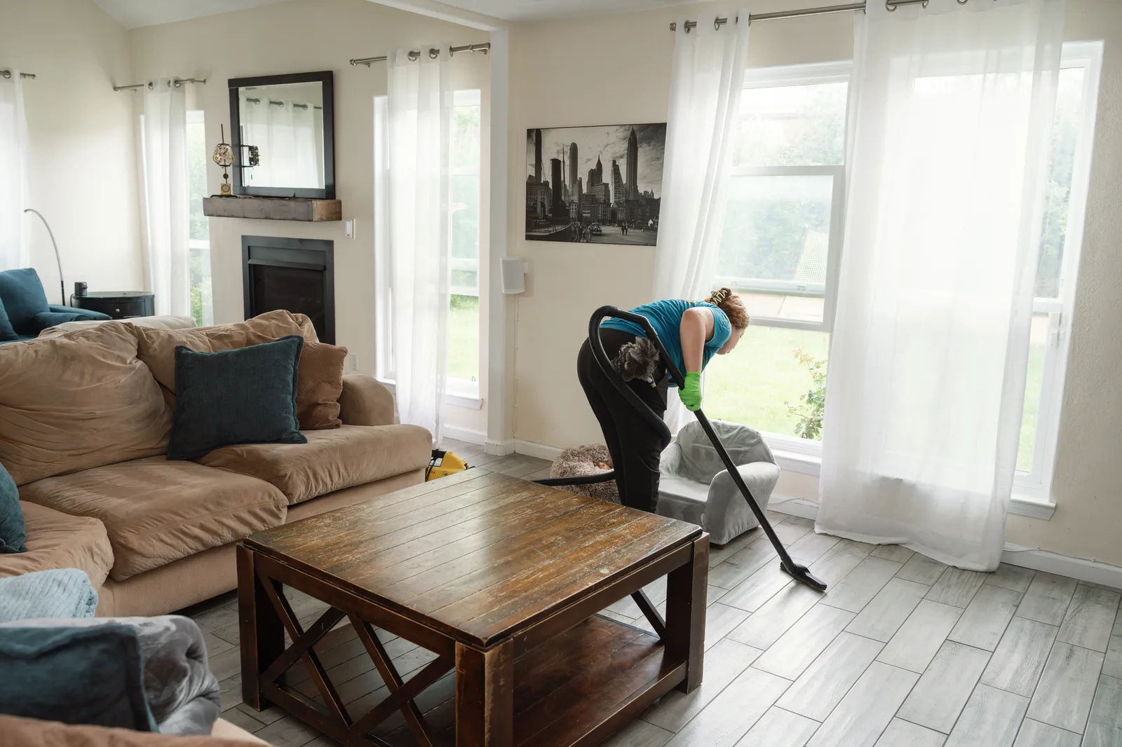 Sandia Green Clean team member vacuuming a living room floor