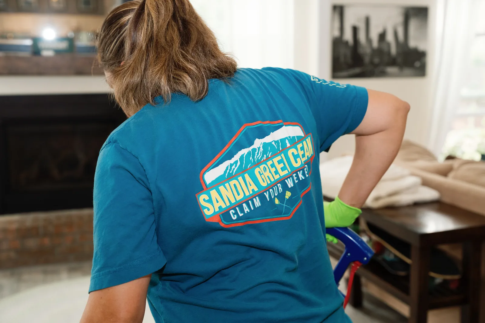 Sandia Green Clean team member in branded Claim Your Weekend shirt