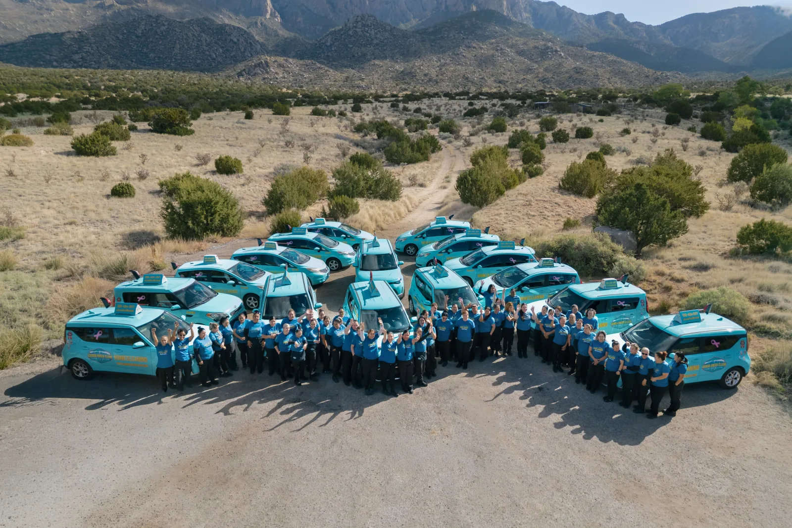 The familiar green Sandia Green Clean van on a dirt lane in Corrales